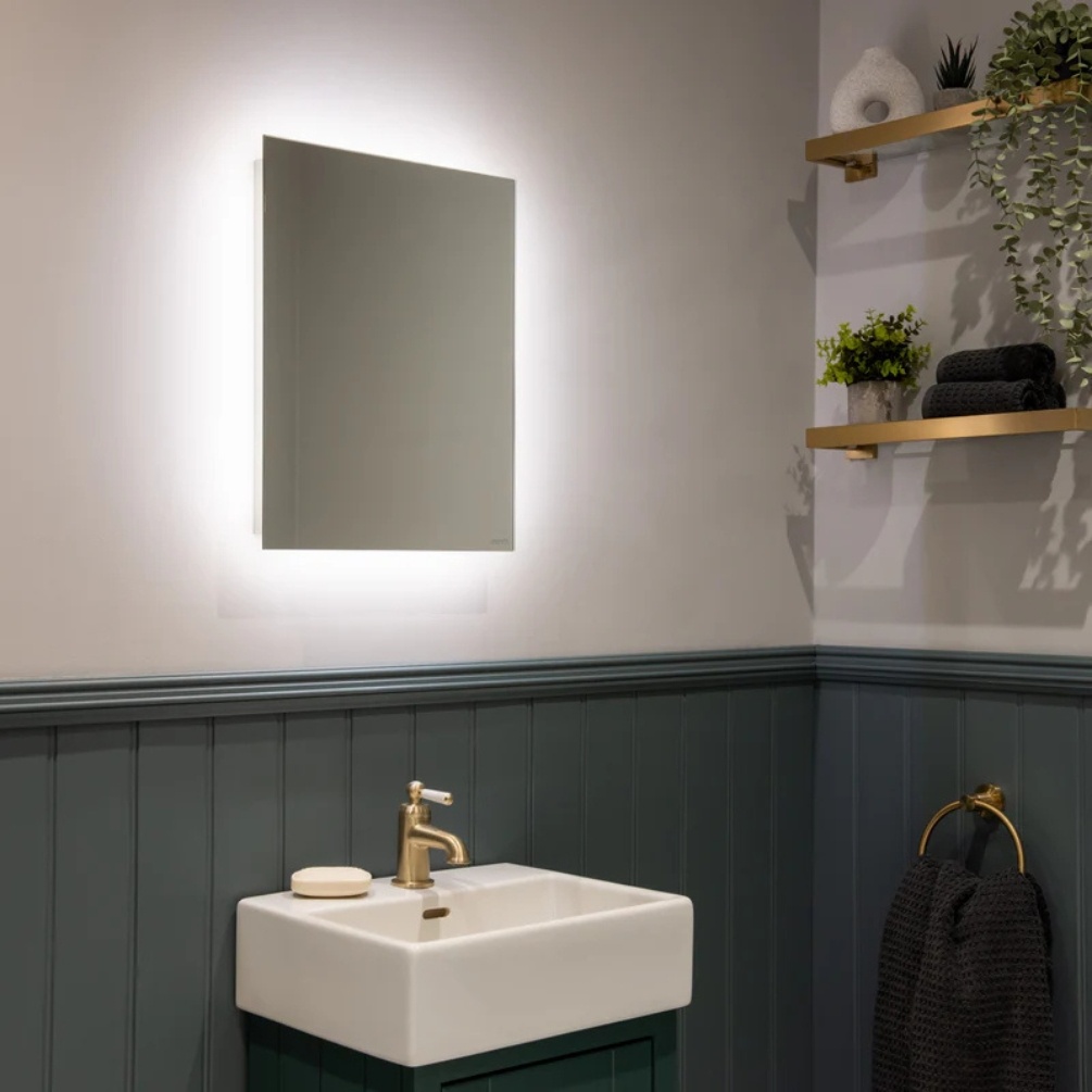 Lifestyle image of the Sensio Lustro Rectangle 500mm x 390mm Rechargeable Backlit LED Mirror mounted on bathroom wall, above a vanity unit & basin